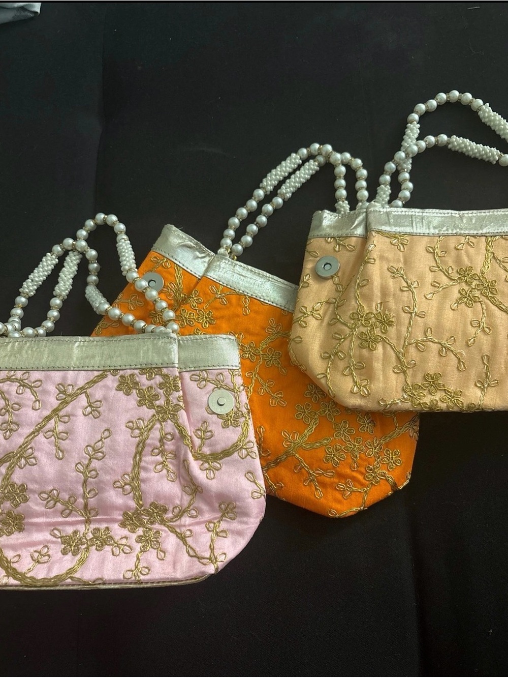 BUNDLE OF THREE traditional clutch with beaded straps and detailing